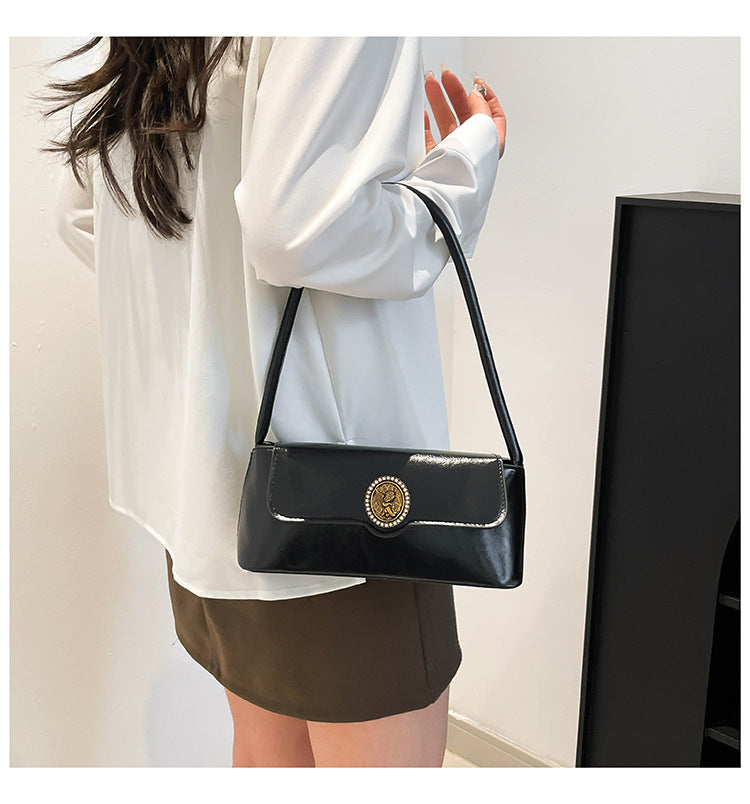 Classic Black Patent Shoulder Bag with Vintage Medallion Clasp