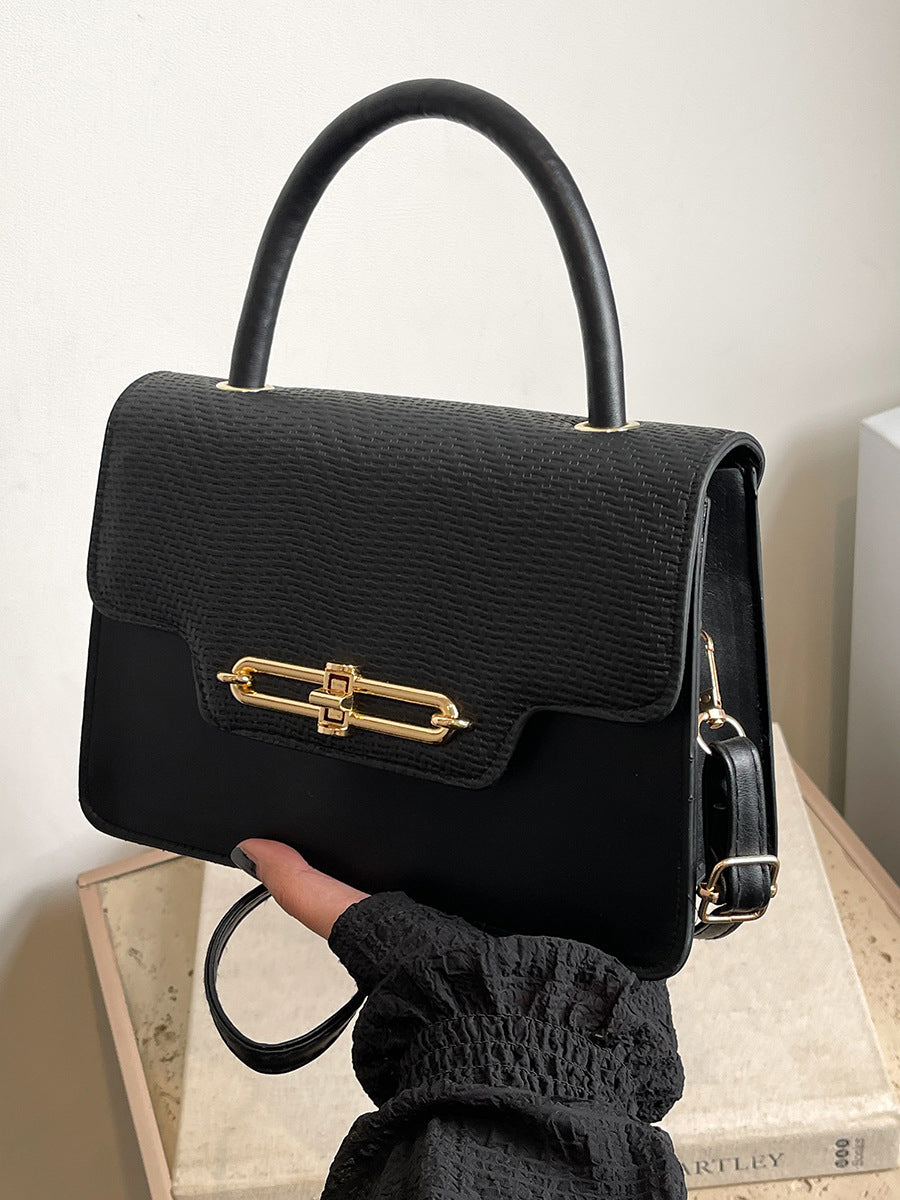 Elegant Black Leather Top-Handle Handbag with Gold Hardware